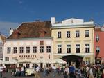 Tourists and locals alike gather in the town square to welcome the car racers.