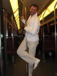 Erik does a pole dance on the subway. 