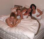 Four ladies in one bed.  Good thing it's white!