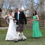 Anita is escorted by her father Tim, followed by Laurie shaking her maracas.