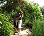 Cherie and Greg in under a canopy of roses.