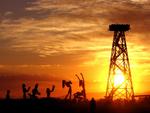 Sunrise at "Crude Awakening" in the Black Rock Desert.  Nine steel sculptures (weighing 7 tons each) sprawled around a 90-ft tall Oil Derrek in various poses of worship during Burning Man 2007.