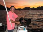 Mike grills up a trio of steaks on the boat's BBQ at sunset.