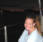 Cherie enjoys the final moments of light on the deck of Snow Goose.