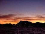 A sliver of moon over Cabo San Lucas.