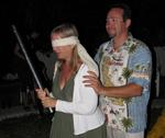 Dustin puts the blindfold on Sylvia.