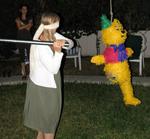 Sylvia gives the Pooh pinata a whack!