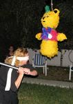 Cherie gets serious with the pinata!  Off with your legs!