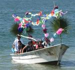 Each panga, or fishing boat is draped in ribbons, balloons and paper flowers.