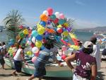 The crowd rushes to help each panga as it barges up the beach.