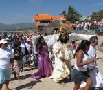 The town follows the priest, "Mary", and her angels to church.