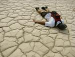 Greg stops to rest on an ancient cracked lakebed.