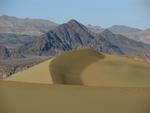 A sand mountain juxtaposed against a granite mountain.