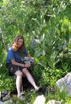 Anita filtering water by a stream.  Dinner is full of carbs and calories!