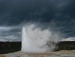 Despite the storm warnings, Old Faithful geyser erupts.