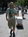 Dragging a cooler up the street.