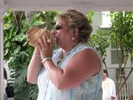 To the delight of the audience, Sue plays a tune on the conch.