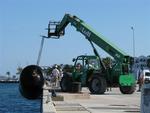 You know it's a big ship when you have to move the fenders with a crane.