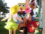 Silvia & Michael with the pinata backdrop at the 7-C's cocktail party