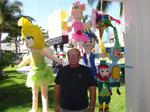 Charlie surrounded by pinatas. 