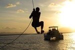 Michael swinging into the ocean at sunset!